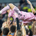 Photo of Messi lifted by teammates after winning league cup trophy