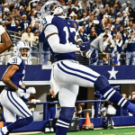 New York Giants quarterback Drew Lock attempts a pass under pressure from the Dallas Cowboys defense during the Thanksgiving Day game at AT&T Stadium..