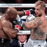 Jake Paul celebrates his victory over Mike Tyson in a controversial fight, with boos echoing from the crowd at AT&T Stadium, Arlington, Texas.