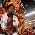 Clemson players celebrate their victory in the ACC Championship, while Arizona State fans cheer in the background, as the win boosts the Sun Devils' chances for a first-round bye in the College Football Playoff.