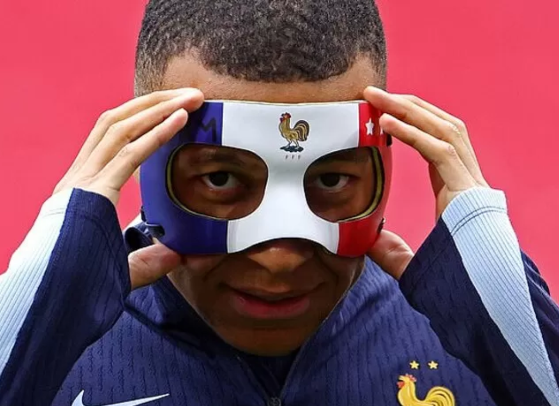 Photo of Mbappe's mask adjustment.