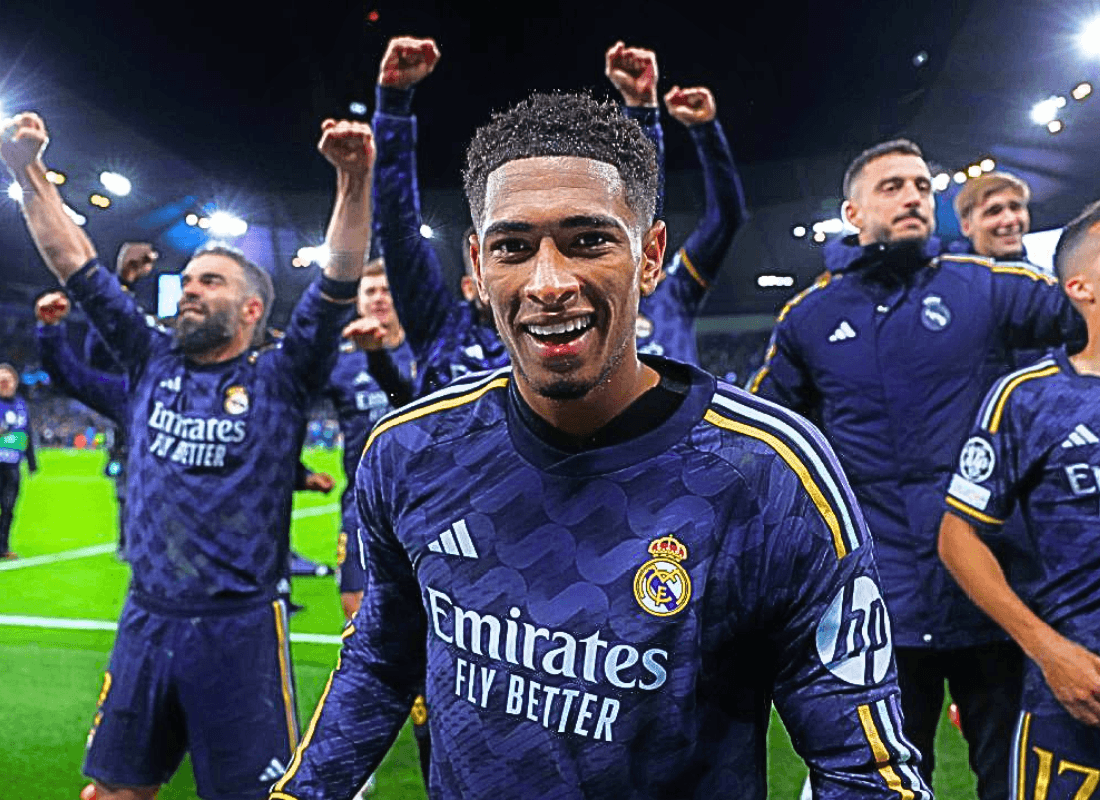 Real Madrid players are celebrating a crucial victory over Manchester City in a dramatic Champions League match, with jubilant expressions and fans cheering in the background.