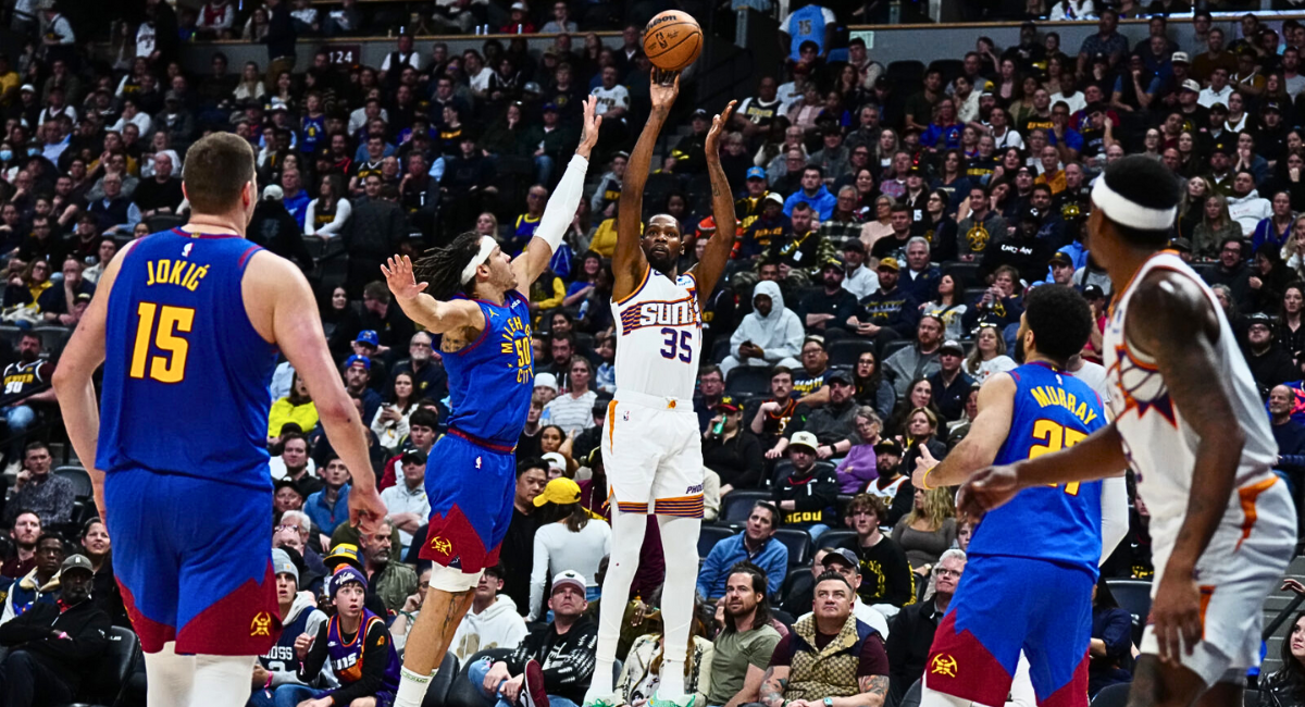 Live action from the Suns vs. Nuggets game as Kevin Durant hits a clutch three-pointer to force overtime, keeping the game exciting and intense.